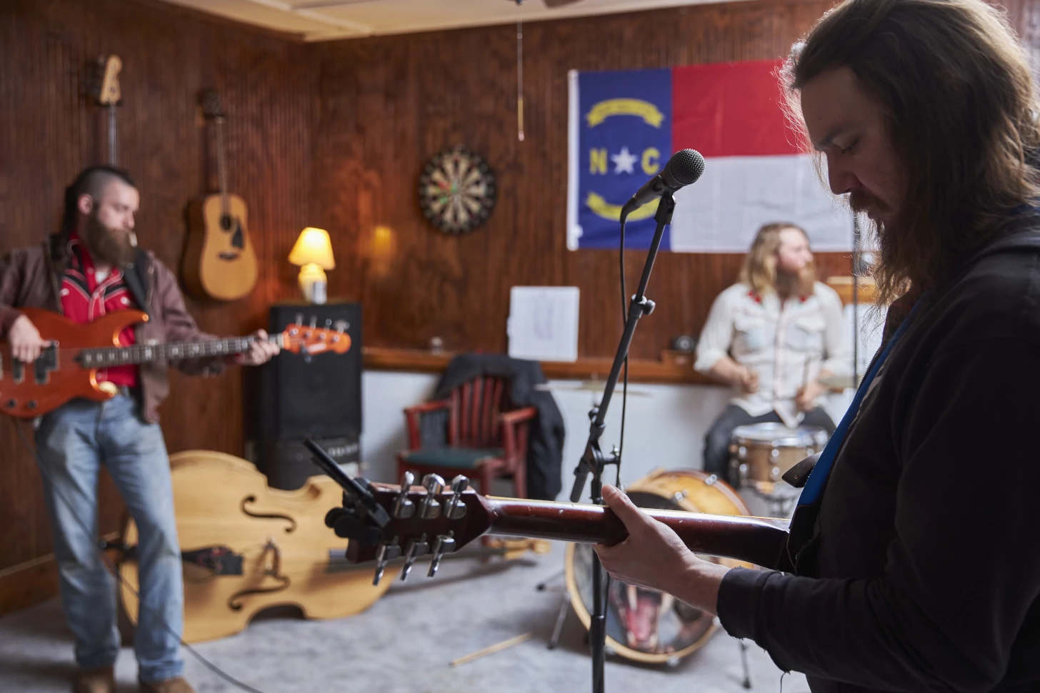 Zach playing guitar in the foreground with Ben and Ernie