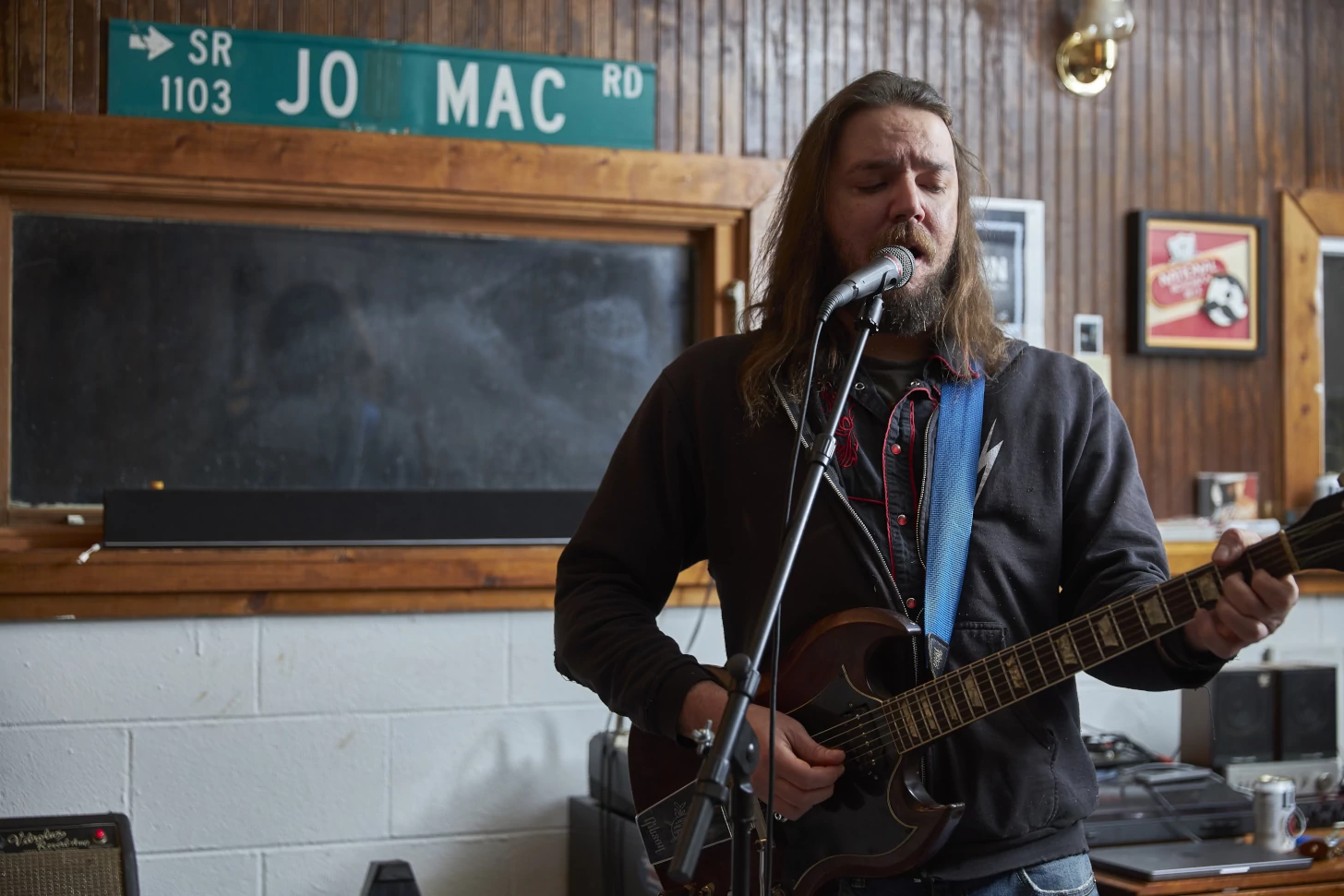 Zach singing and playing guitar